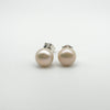 Pair of white pearl button stud earrings in sterling silver, front view