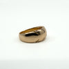 Side angle of antique 12ct rose gold wide band ring, showing smooth curved band and engraved detail