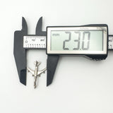 Width of vintage aircraft pendant shown as 23.0mm using digital calipers