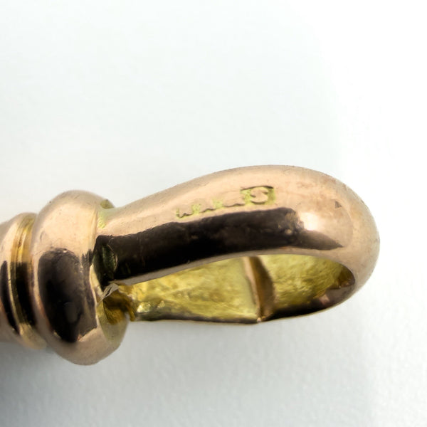 Close up of a worn 9c stamp on the dog clip of an antique 9ct rose gold Albert chain