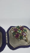 ideo showing vintage 18ct gold ruby emerald and diamond cluster ring in a vintage display box